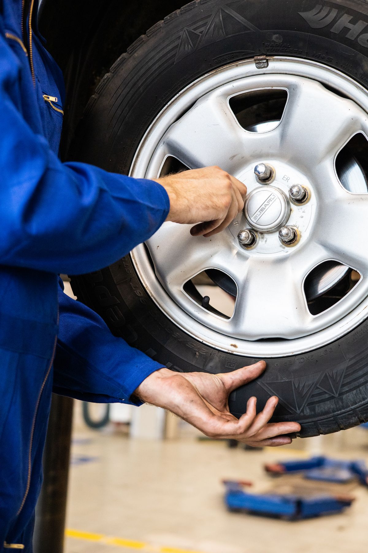 Technician fitting a wheel
