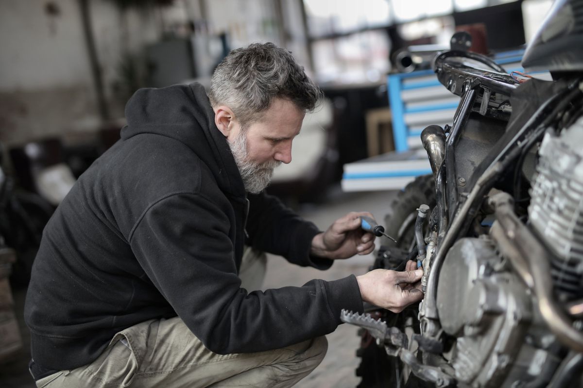 Mechanic working on a motorbike in a workshop